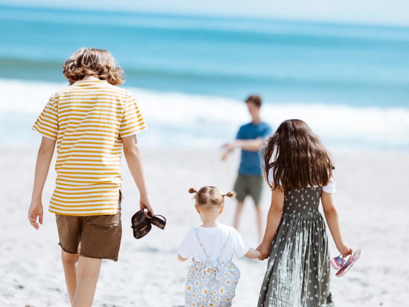 Issy Butson's family walking on the beach 