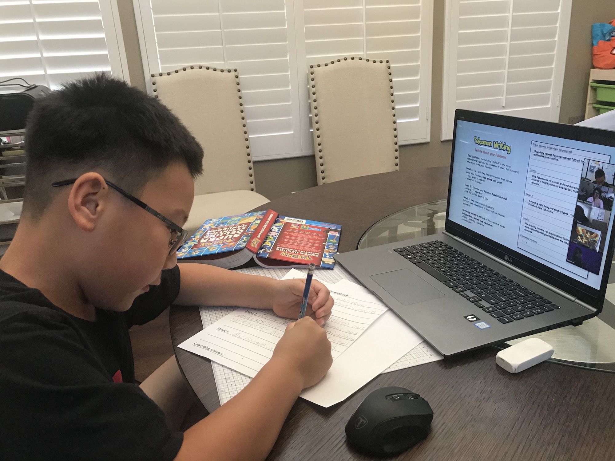 Young boy in front of computer practicing cursive writing